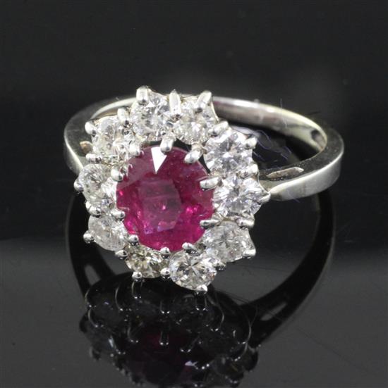 A white gold, ruby and diamond cluster ring, size O.